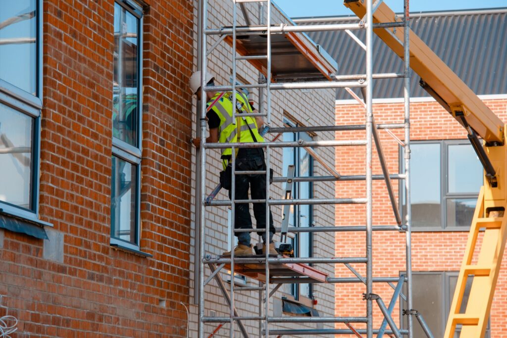 construction workers using aluminium mobile scaffold tower safety harness work height Large